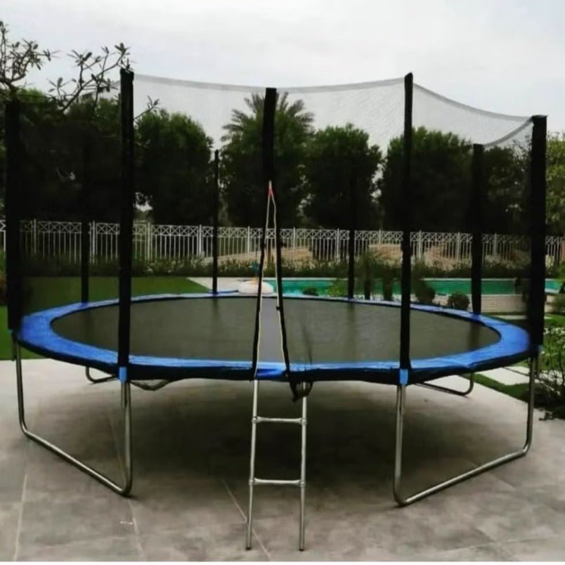 Large round trampoline for sale UAE with safety netting and ladder in outdoor setting